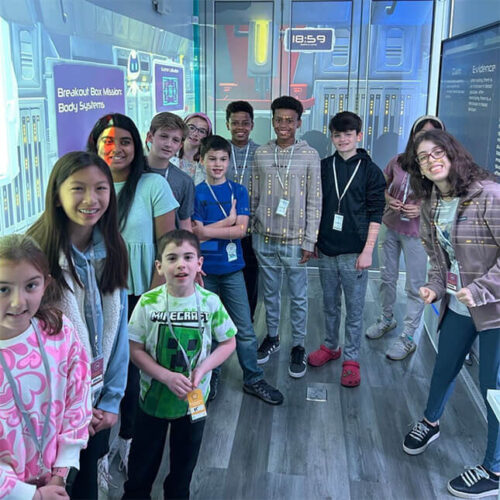 students in high tech mobile stem lab smiling in group pic