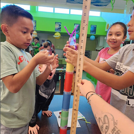 students stack paper cones in engineering challenge