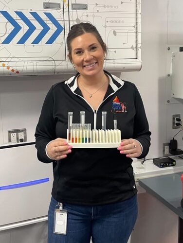 volunteer smiling with pipettes