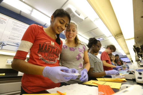 smiling emerging leaders female students in the lab doing chemistry
