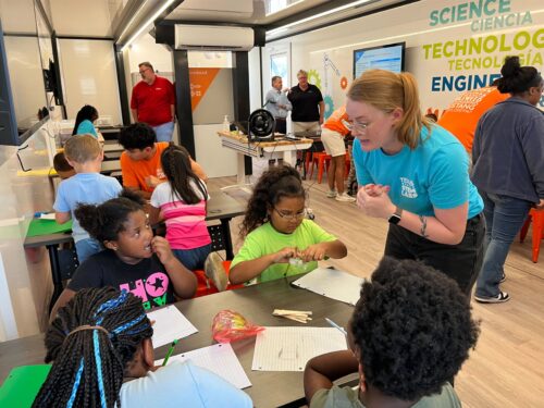 students and teacher working the challenge in the learning undefeated mobile stem lab