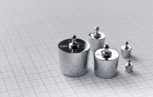 Metallic weights on background of millimetre paper