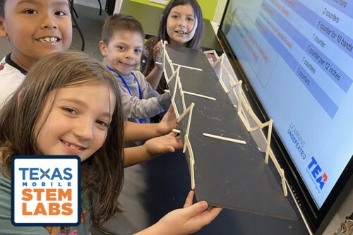 children building popsicle stick bridge
