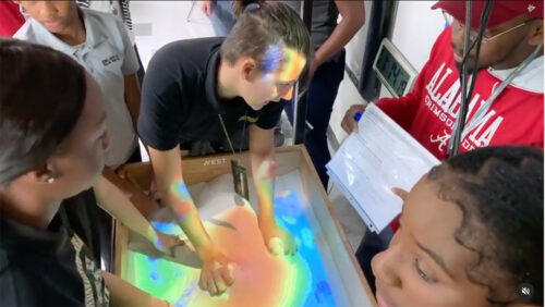 students work on city planning lab in virtual reality sandbox