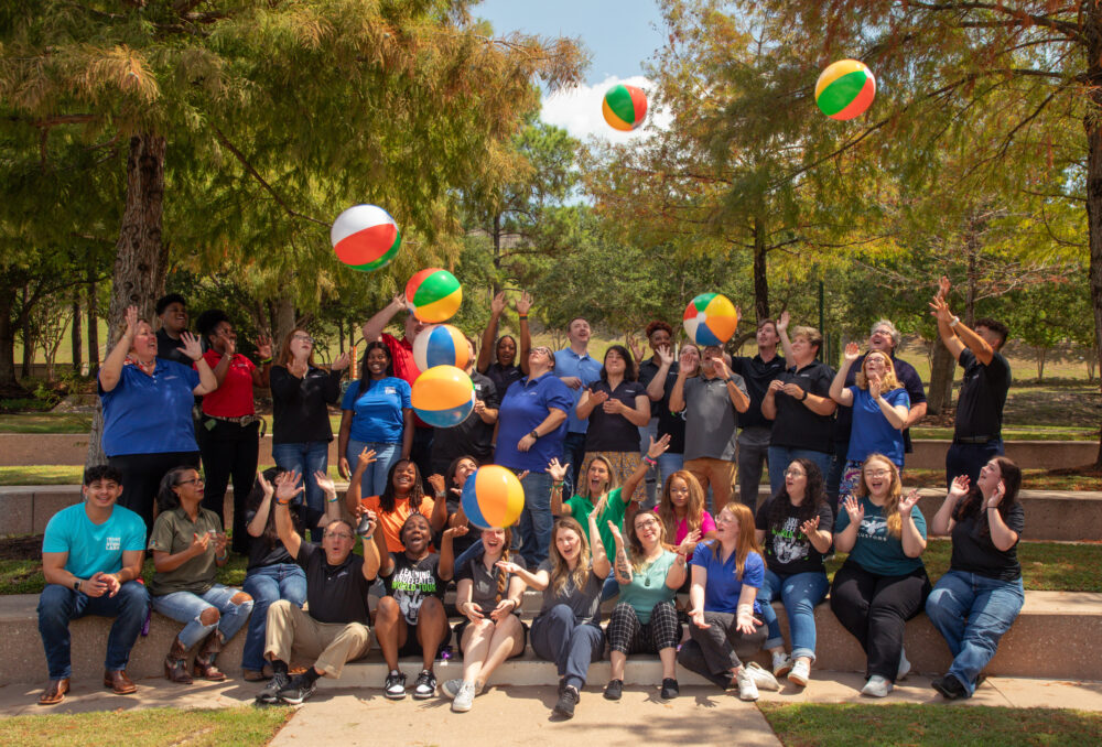 group photo, Learning Undefeated team with beach balls in air