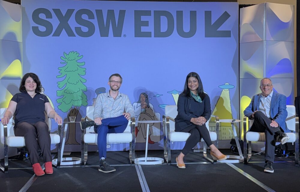 Four people on a stage. Panelists at SXSW Edu, Game On session