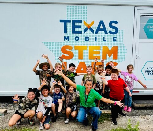 a group of students and a Learning Undefeated educator outside a Texas Mobile STEM Lab